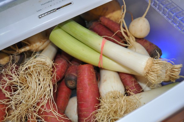 overflowing with purple carrots, leeks and turnips